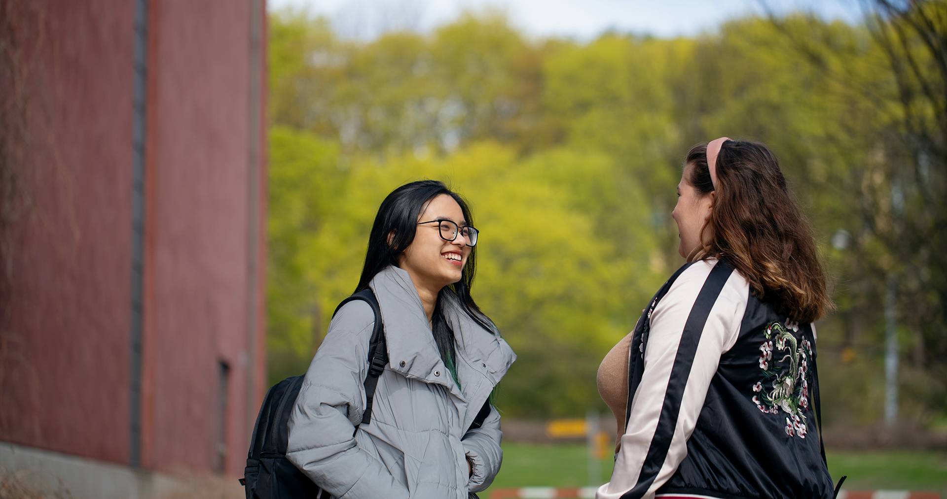 Two people conversing outdoors.